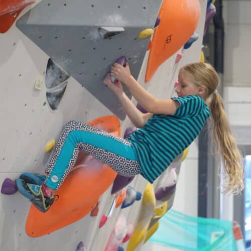 A young girl on a bouldering wall